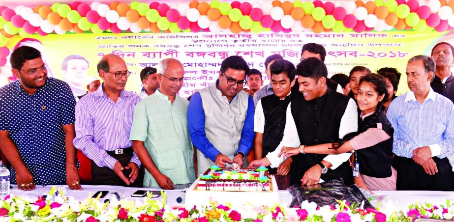 DSCC Mayor Sayeed Khokon inaugurating Bangabandhu Sheikh Mujib Festival-2018 by cutting cake at Azimpur Government Colony field in the city on Thursday marking Bangabandhu's birthday.