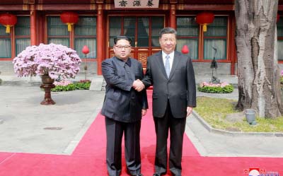 China's President Xi Jinping shaking hands with North Korean leader Kim Jong Un in Beijing..