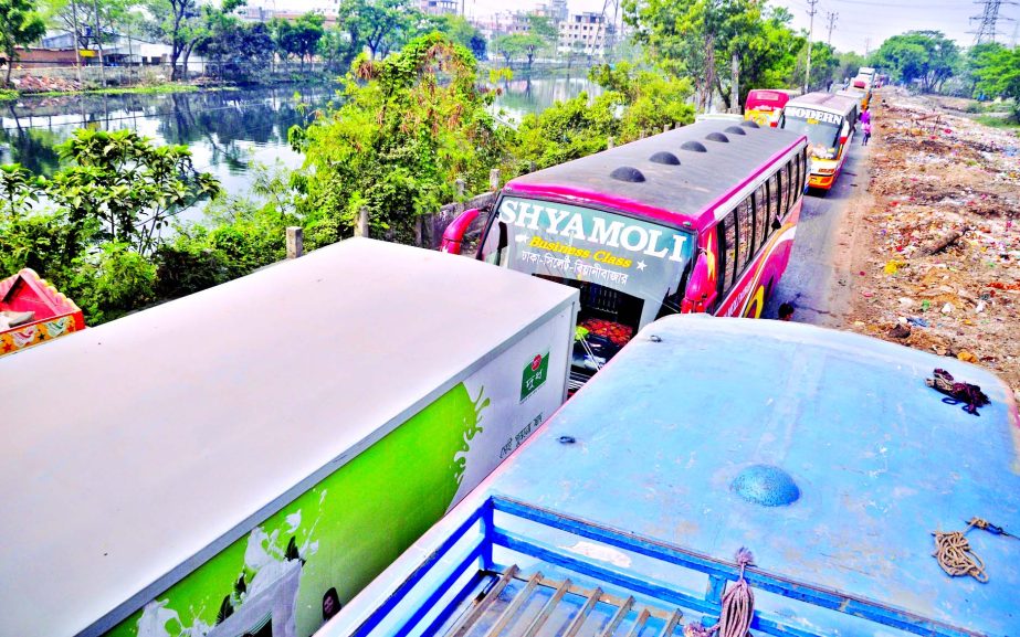 Hundreds of vehicles got stuck in a 10-kilometer long tailback on Dhaka-Sylhet Highway near Sultana Kamal Bridge, causing sufferings to commuters. This photo was taken from western side of the bridge area on Friday.