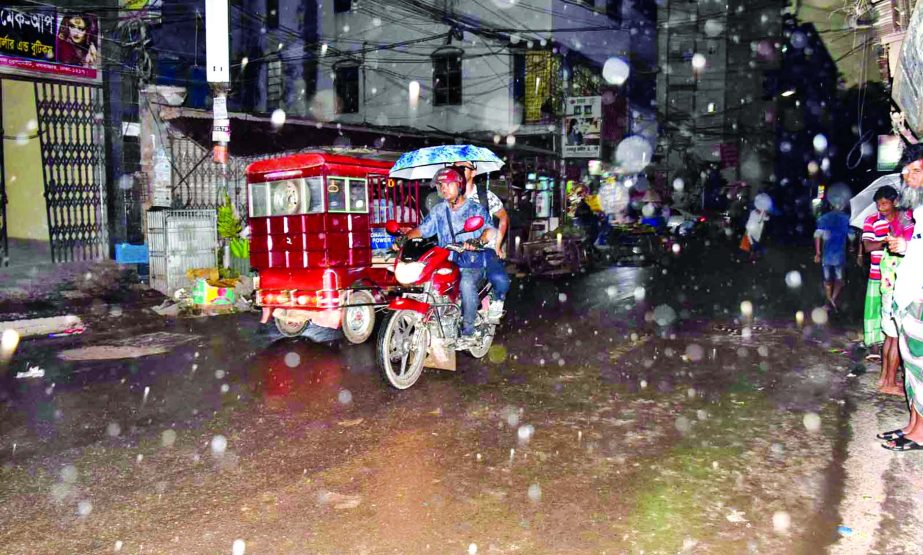 People from all walks of life heaves a sigh of relief soon after a short spell of rains coupled with hail storms as hot weather prevailing in country. This photo was taken from Maghbazar area in city on Friday.