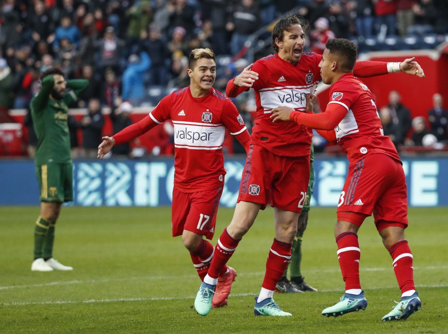 Chicago Fire defender Brandon Vincent (right) celebrates with forward Alan Gordon (second right) after scoring against the Portland Timbers during the second half of an MLS soccer match in Bridgeview on Saturday.