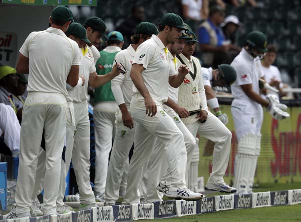 Australia's players walk onto the field as South Africa prepare to bat for the second innings on day three of the fourth cricket Test match between South Africa and Australia at the Wanderers Stadium in Johannesburg, South Africa on Sunday.