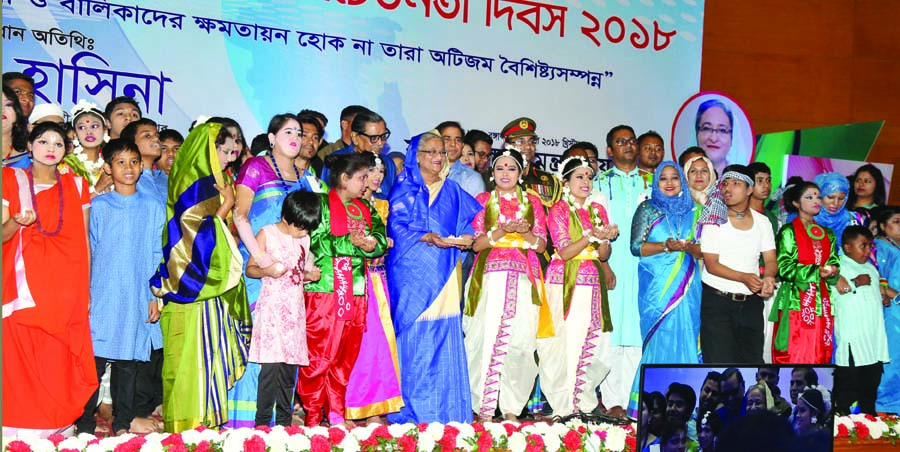 Prime Minister Sheikh Hasina poses for photograph with the recipients of awards at a ceremony organised on the occasion of World Autism Awareness Day at Bangabandhu International Conference Center in the city on Monday. PID photo