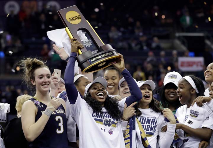 Notre Dame's Arike Ogunbowale holds the trophy after defeating Mississippi State in the final of the women's NCAA Final Four college basketball tournament, Sunday in Columbus, Ohio. Notre Dame won 61-58.