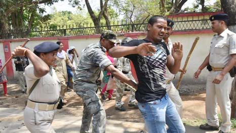 Indian police beat a protester with batons during a countrywide strike in Ranchi, the capital of Jharkhand state