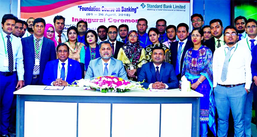 Mamun-Ur-Rashid, Managing Director of Standard Bank Limited, poses with the participants of a four-week long training on "Foundation Course on Banking" at the banks training institute in the city recently. Md. Zakaria, Principal and Md. Amzad Hossain Fa