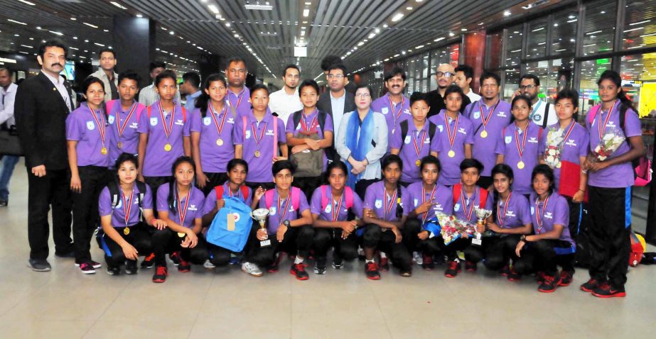 The officials of Bangladesh Football Federation receiving the members of Bangladesh National Under-15 Women's Football team at the Hazrat Shahjalal International Airport on Monday night. Bangladesh National Under-15 Women's Football team became champion