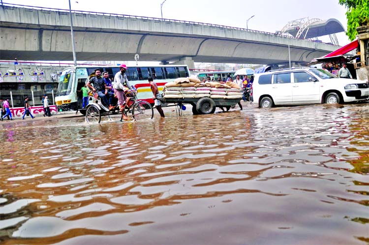 Pedestrians and vehicles are suffering immensely as dirty and stinky water being stagnant on the busy South Point Road of Bangabhaban. This photo was taken on Wednesday.
