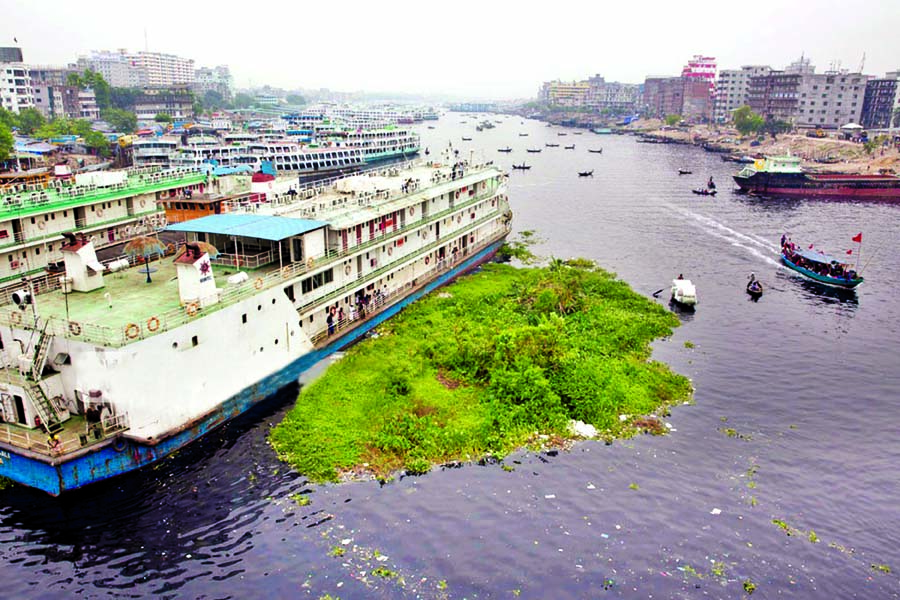 Factory garbage spilled over in the middle of Buriganga River making the water poisonous and its colour turn black and stinky. Such floating garbage is also obstructing movement of launch and boats exposing them to periodic accidents for long. This photo