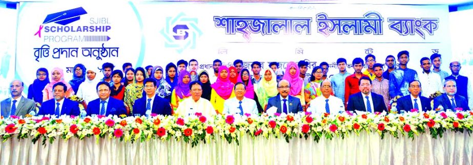 Bangladesh Bank Governor Fazle Kabir, poses with the scholarship winner students at a scholarship award giving ceremony organized by Shahjalal Islami Bank Limited at Officers Club in the city recently. Akkas Uddin Mollah, Chairman, Farman R Chowdhury, Man