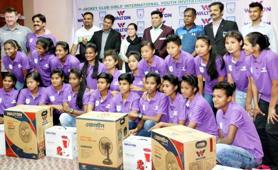 Members of Bangladesh National Under-15 Women's Football team with the official of Walton Group and Bangladesh Football Federation (BFF) pose with the home appliance of Walton at the conference room in BFF House on Thursday.