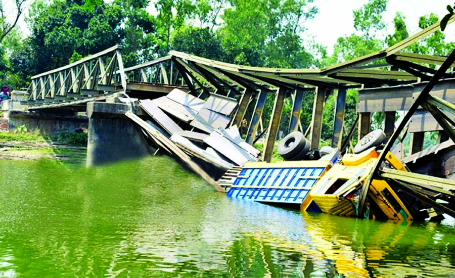 Mathpara Brailey bridge collapsed into river on Thursday soon after a stone laden truck tried to cross it at Dhanute upazila in Bogura, disrupting communications. This photo was taken on Thursday.