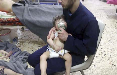 Photo shows a medical worker giving toddlers oxygen through respirators following an alleged poison gas attack in the opposition-held town of Douma, in eastern Ghouta, near Damascus on Sunday.