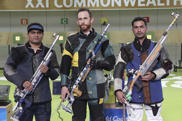 Winner Dane Sampson of Australia (center) poses with Abdullah Hel Baki of Bangladesh (left) silver, and Ravi Kumar of India (bronze) for a photo during the men's 10m Air Rifle finals at the Belmont Shooting Centre during the 2018 Commonwealth Games in Br
