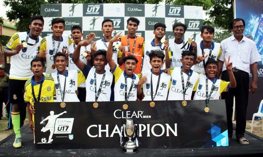 Members of Bagerhat Pilot Collegiate School, the champions of Khulna Division of 'Clear Men Bangladesh Under-17 Football Championship' pose for photo at Khalishpur City Corporation Ground in Khulna on Saturday. Clear Company, the manufacturer of number