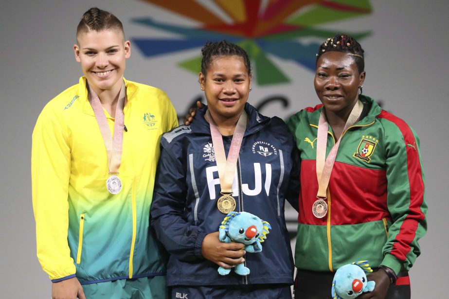 From left : Silver medalist Kaity Fassina of Australia, gold medalist Eileen Cikamatana of Fiji and bronze medalist Clementine Meukeugni Noumbissi of Cameroon stand with their medals during the medal ceremony for women's 90kg weightlifting at the Carrar