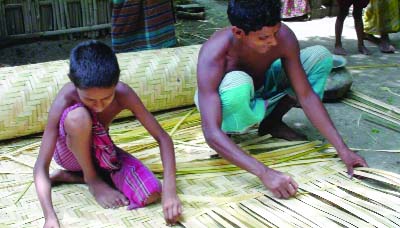Saidpur (Nilphamari): Family members engaged in bamboo goods making at Saidpur