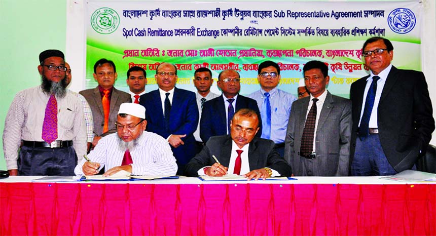 Thakur Das Kundu, GM of Bangladesh Krishi Bank (BKB) Limited and Md. Saidur Rahman, General Manager of Rajshahi Krishi Unnayan Bank (RAKUB), signing an agreement to increase the flow of remittance at BKB Staff College auditorium in the city on Tuesday. Md