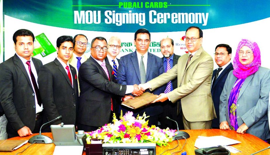 Md. Abdul Halim Chowdhury, Managing Director of Pubali Bank Limited and Safiul Alam Khan Chowdhury, AMD of Rose View Hotel, Sylhet, exchanging a MoU signing documents at the banks head office in the city on Tuesday. Under the deal, all Debit and Credit Ca