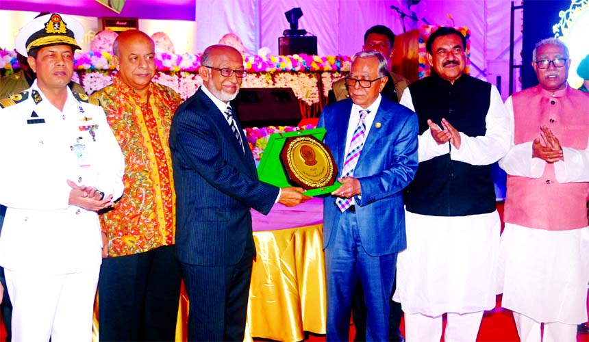 President Abdul Hamid, handing over a honourary crest to Managing Director of Haq's Bay Automobiles Limited Abdul Haque for his outstanding contribution to the country's economy at the 67th anniversary function of the Mongla Port recently.