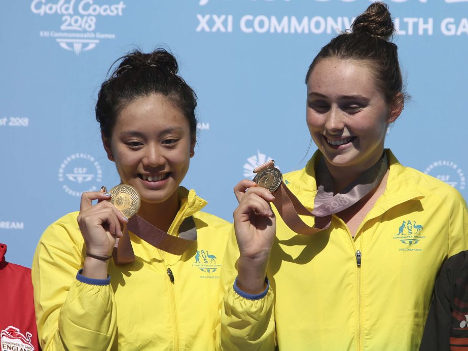 Australia's Esther Qin (left) and Georgia Sheehan show their gold medals after winning the women's synchronised 3m springboard final at the Aquatic Centre during the 2018 Commonwealth Games on the Gold Coast, Australia on Wednesday. Australia won gold,