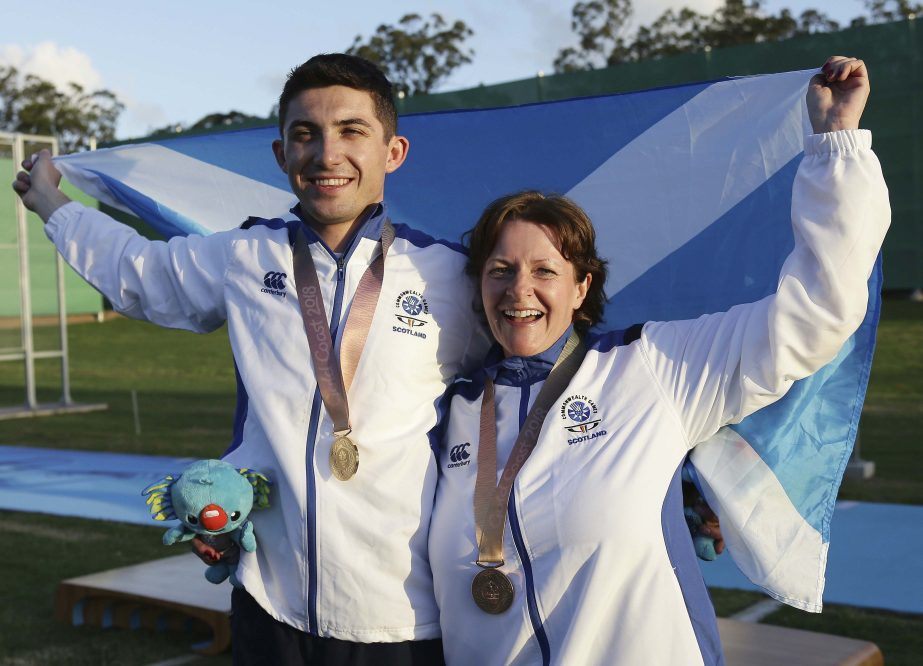David McMath of Scotland (left) and Linda Pearson of Scotland (right) celebrate with their medals after getting gold and bronze in the Double Trap final at the Belmont Shooting Centre during the 2018 Commonwealth Games in Brisbane, Australia on Wednesday.