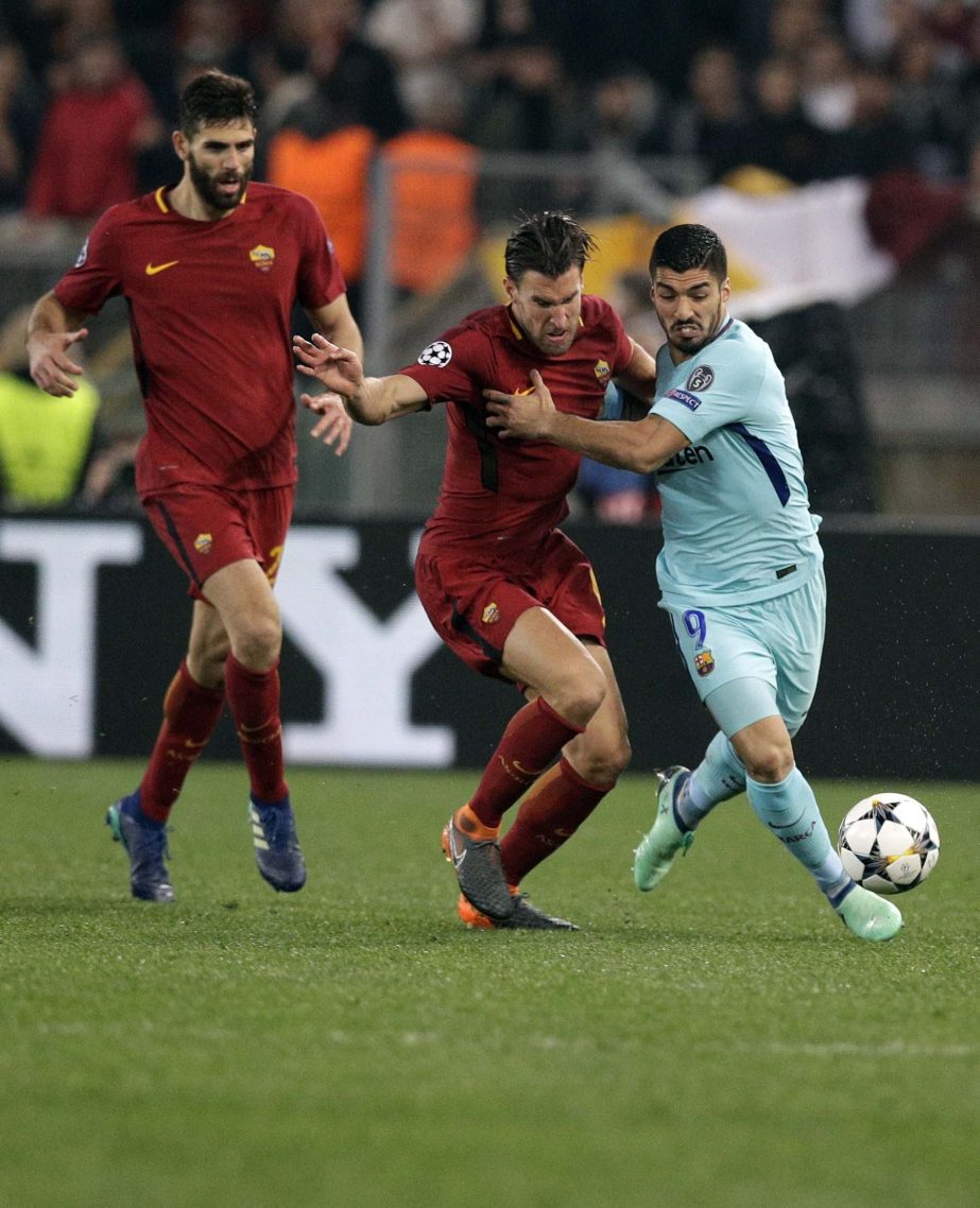 Barcelona's Luis Suarez (right) is challenged by Roma's Kevin Strootman during the Champions League quarterfinal second leg soccer match between Roma and FC Barcelona at Rome's Olympic Stadium on Tuesday.