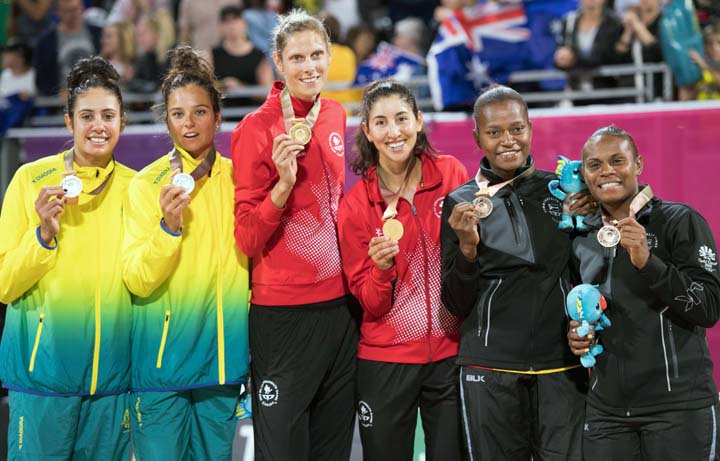 Canada's Sarah Pavan (center left) and Melissa Humana-Paredes (center right) hold their gold medals as silver medallists Mariafe Artacho del Solar and Taliqua Clancy from Australia (left) and bronze medallists Miller Pata and Linline Matauatu of Vanuatu