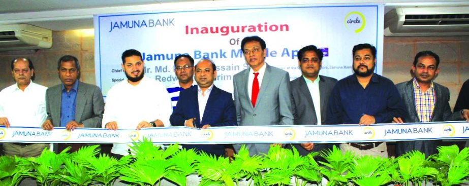 Md. Ismail Hossain Siraji, Chairman, Board of Directors of Jamuna Bank Limited, inaugurating its Mobile Banking apps at the banks head office in the city recently. Redwan-ul-Karim Ansari, Director and AKM Saifuddin Ahmed, DMD of the bank among others were