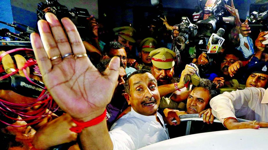 Kuldeep Singh Sengar, a legislator of Uttar Pradesh state from India's ruling Bharatiya Janata Party (BJP), reacts as he leaves a court after he was arrested in connection with the rape of a teenager, in Lucknow on Saturday.