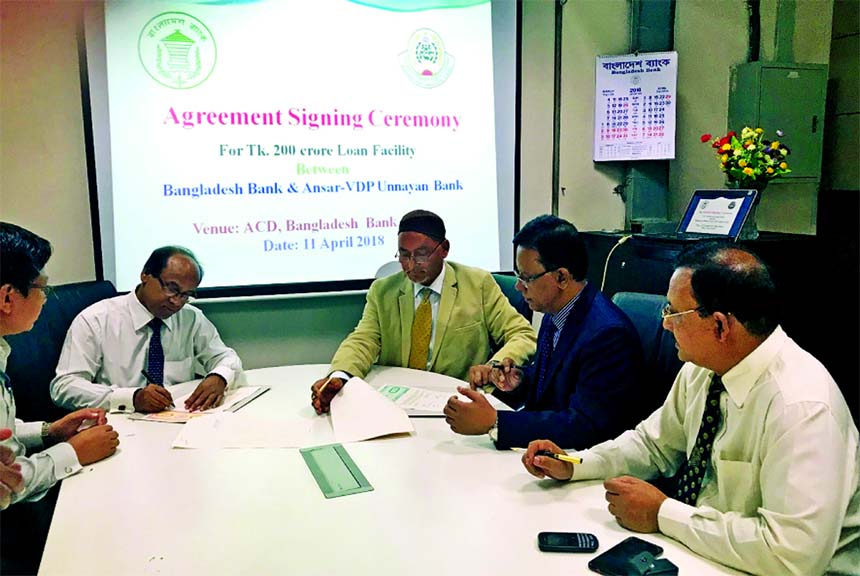 Mohammad Jalal Uddin, Managing Director of Ansar-VDP Unnayon Bank and Monoz Kanti Boiragi, General Manager of Agri and Rural Credit Division of Bangladesh Bank, signing an agreement on Tk. 200 crore loan for distributing among the members of Ansar-VDP in