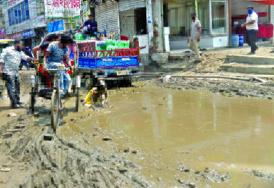 A teenage girl is struggling to recover from a knee deep muddy water on a road at Chunkutia in Keraniganj on the outskirts of the city. Such accidents often take place in the busy road but there is none to take care.