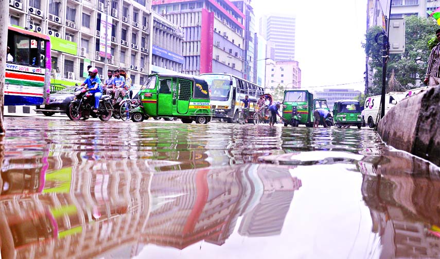 A busy portion of Motijheel area went under rain water due to lack of proper drainage system, creating obstacles to movement of vehicles, causing sufferings to commuters. This photo was taken on Thursday.