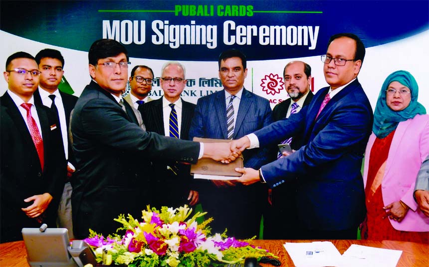 Md. Abdul Halim Chowdhury, Managing of Pubali Bank Limited and Khondoker Asaduzzaman, Group General Manager of BRAC Services Limited, exchanging an MoU signing documents at bank's head office in the city recently. Under the deal, all Debit and Credit Car