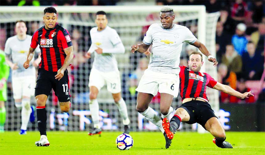 Manchester United's Paul Pogba (second right) and Bournemouth's Steve Cook battle for the ball, during the English Premier League soccer match between Bournemouth and Manchester United, at the Vitality Stadium in Bournemouth, England on Wednesday.