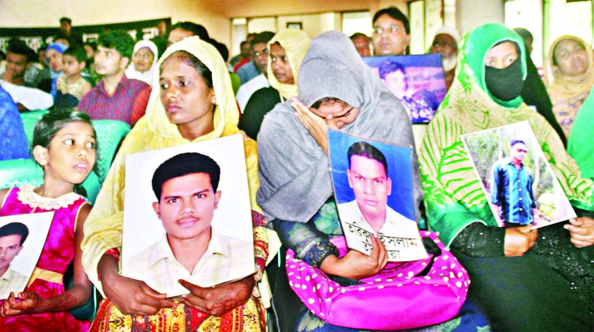 Relatives of persons who disappeared or killed wailing along with the photos of the victims in front of Jatiya Press Club on Saturday .