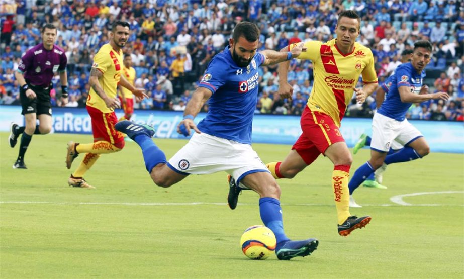 Cruz Azul's Martin Cauteruccio (center) ready to strike the ball as Morelia's Carlos Rodriguez attempts to stop him during a Mexico League soccer match between Cruz Azul and Morelia at Azul Stadium in Mexico City on Saturday. This is the last match the