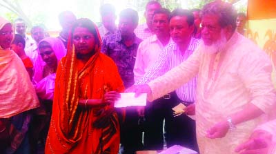 SAGHATA(Gaibandha): Deputy Speaker of Jatiya Sangsad Adv Md Fazle Rabbi Miah MP distributing loan among the poor women of Kukhatair Nari Unnoyan Samabay Samity Ltd at Saghata Upazila on Sunday.