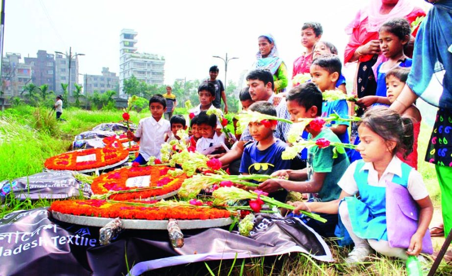 Relatives and members of various workers' organisations placing floral wreaths at the graves of Rana Plaza tragedy victims at the Jurain gravyard on Tuesday.