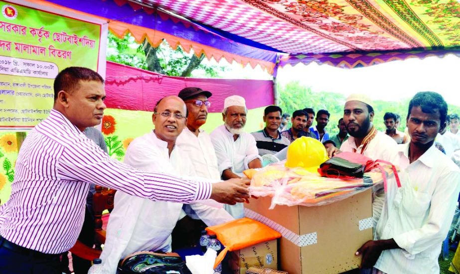 RANGABALI (Patuakhali): Delowar Hossain, Chairman, Rangabali Upazila and A B M Abdul Manna, Chairman, Chhotobaishdia Union distributing lifejacket, raincoat and helmets among the volunteers of Cyclone Preparation Programme (CPP) on Wednesday.