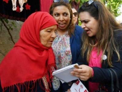 Ines Boussetta Â®, who heads the list of the Nidaa Tounes party for municipal elections in Tebourba, campaigns in the town some 35 kilometres west of the capital on Thursday.