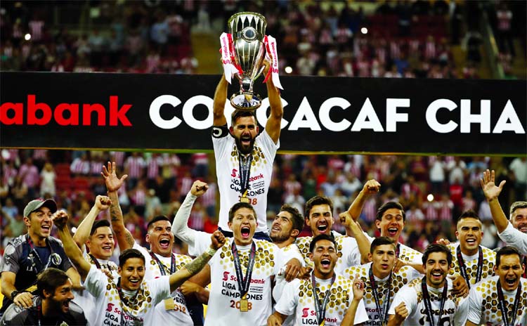 Chivas players hold the trophy aloft as they celebrate winning the CONCACAF Champions League final soccer match in Guadalajara, Mexico on Wednesday. Chivas defeated Toronto FC in a penalty shoot out.