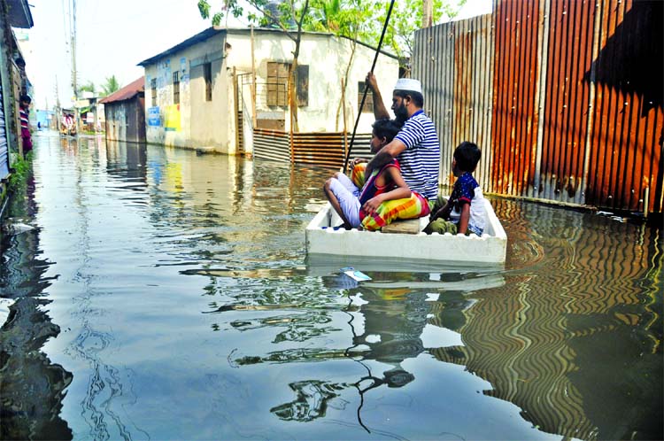 People of Dhaka-N'ganj-Demra (DND) Project area faces sufferings as the rain waters submerged the road in absence of proper drainage system. Photo shows makeshift boats made by locals are the source of transport to move. This photo was taken from city's