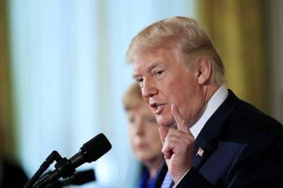 President Donald Trump with German Chancellor Angela Merkel speaks during a news conference in the East Room of the White House in Washington on Friday.