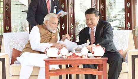 Chinese President Xi Jinping and India's Prime Minister Narendra Modi sit as they take a boat ride on the East Lake in Wuhan, China on Saturday.