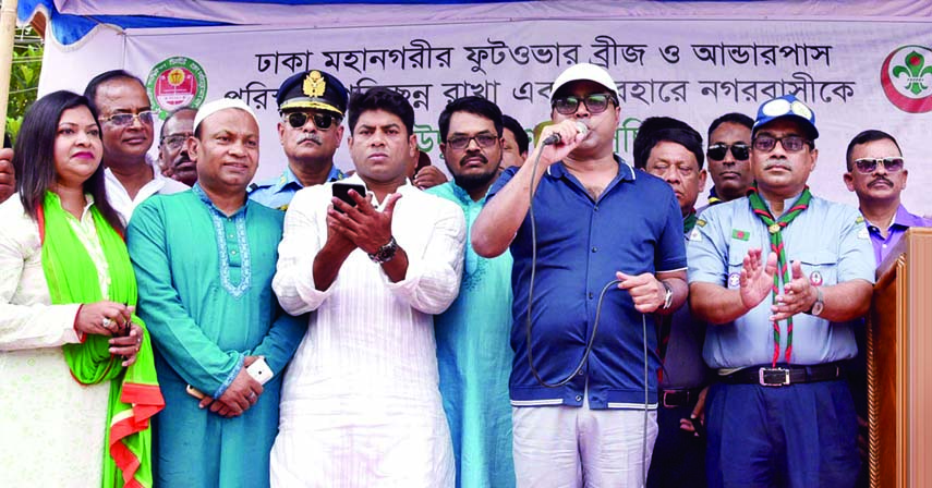 Dhaka South City Corporation Mayor Sayeed Khokon speaking at the inauguration of a campaign to keep neat and clean foot-over bridge and underpass of the city at Shahbag area on Saturday.