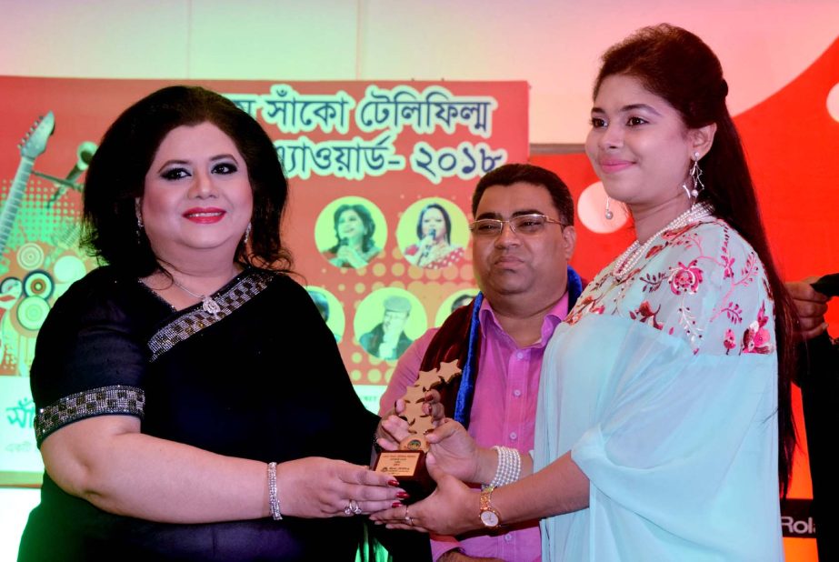 Promising singer Zinia Zafrin Luipa receiving â€˜14th Shako Telefilm Music Award as Best Singer from legendary singer of the Subcontinent Runa Laila at a hotel in the city on Friday night.
