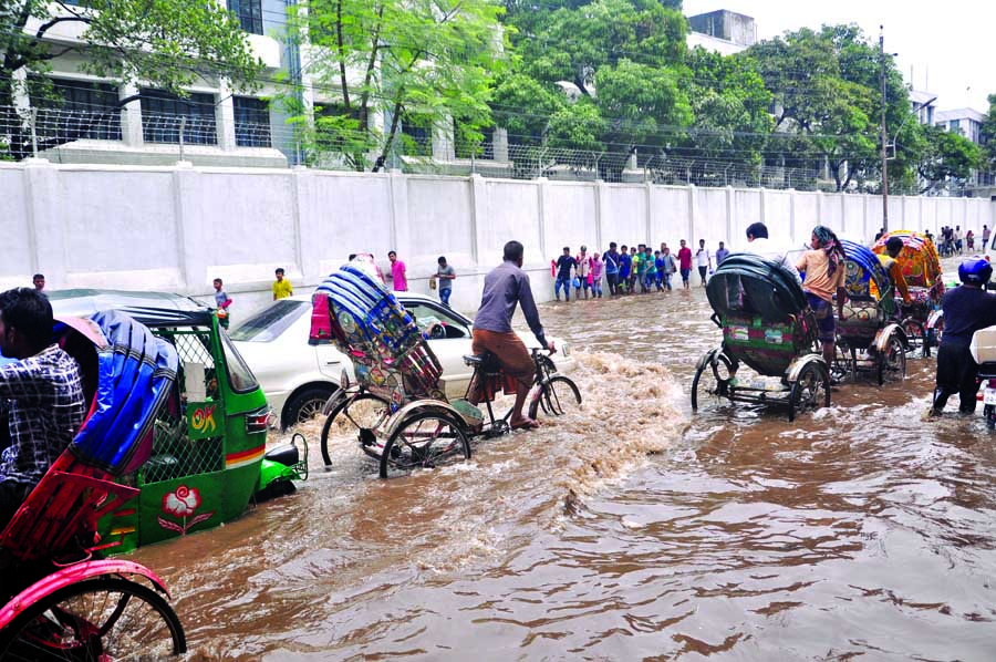 Many areas of the capital have been inundated due to heavy rains affecting the normal life of dwellers and commuters. In absence of proper drainage system the rain water will remain stagnant for several days. This photo was taken from in front of Bangabha