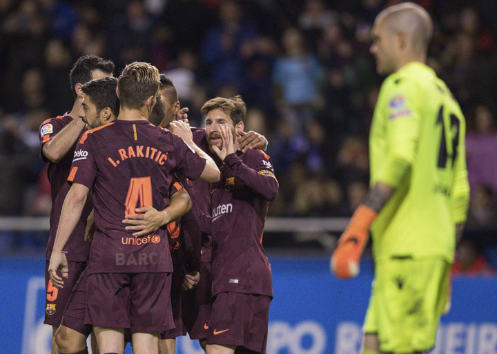 Barcelona's Lionel Messi (center) is congratulated by teammates after scoring a goal during a Spanish La Liga soccer match between Deportivo and Barcelona at the Riazor stadium in Spain on Sunday.