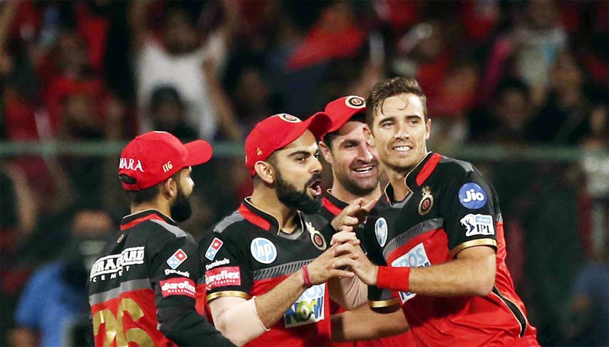 Royal Challengers Bangalore captain Virat Kohli (second left) celebrates with teammates after taking the catch to dismiss Mumbai Indians' Hardik Pandya during the VIVO IPL Twenty20 cricket match in Bangalore, India on Tuesday.